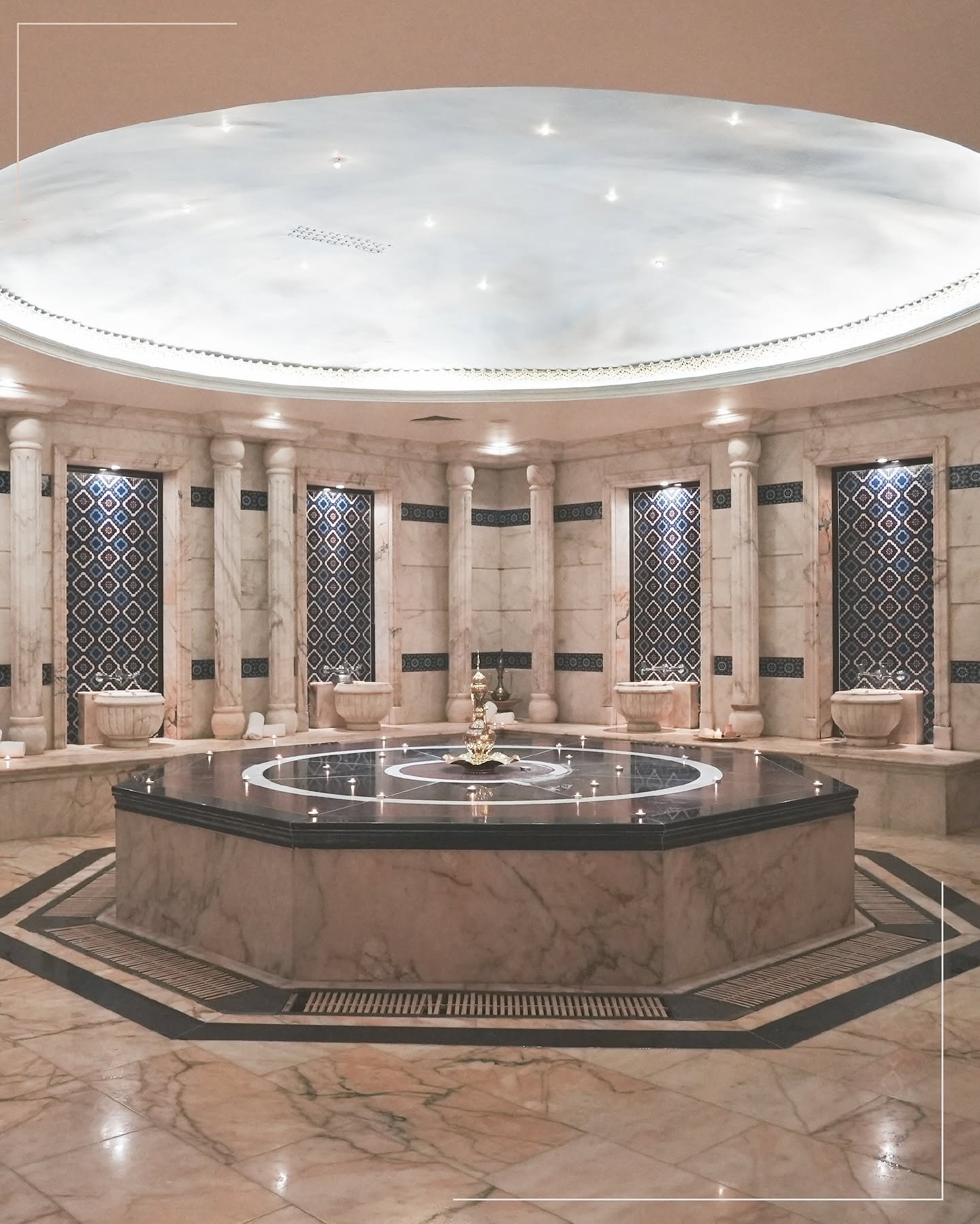 Marble hall beneath the domed ceiling at Alf Layla Turkish Bath