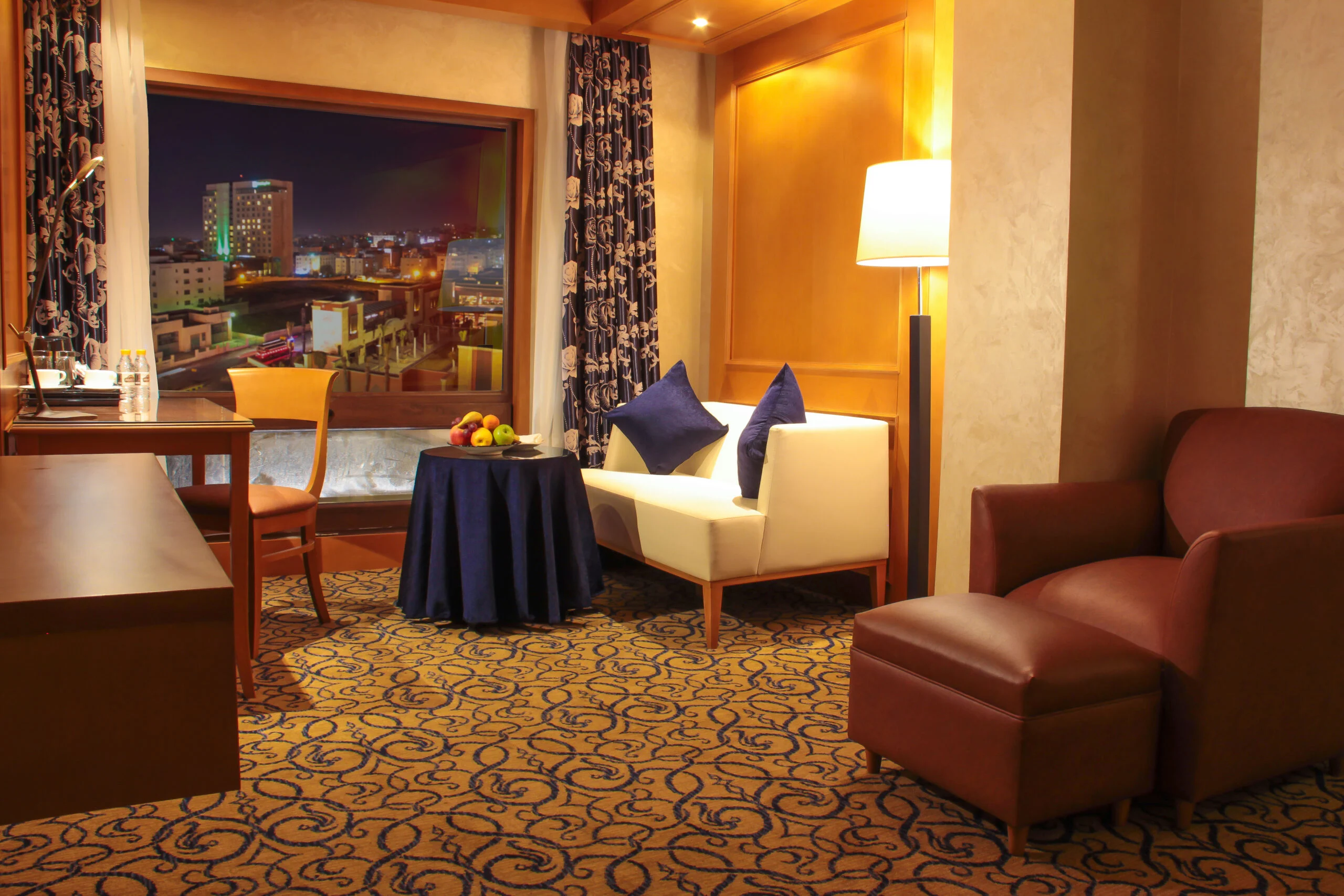 Executive Suite living room with city view at Thousand Nights Hotel
